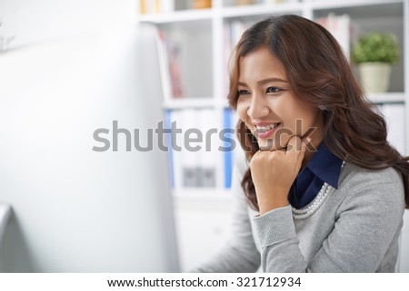 Beautiful young business lady working on computer