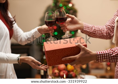 Woman receiving Christmas present from her boyfriend