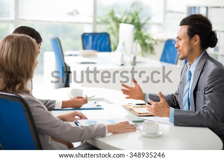 Businessman giving financial report in front of entrepreneurs