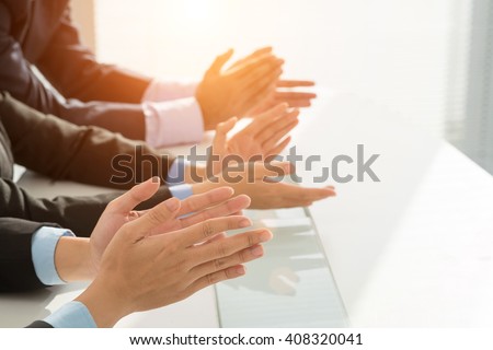 Hands of business people clapping to speaker