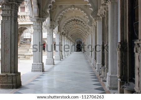AHMEDABAD, GUJARAT / INDIA - AUGUST 20 : Hutheesing Jain Temple on August 20, 2012 in Ahmedabad.  Beautiful colonnaded column structure in the corridor. Ornamental stone carvings on archs in cloister.