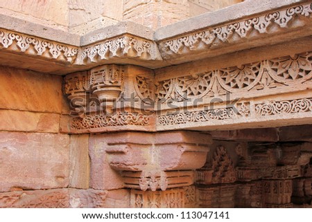 GANDHINAGAR, GUJARAT / INDIA - SEPTEMBER 2 : Adalaj Step Well ( Vav ) on September 2, 2012 in Gandhinagar. Beautiful floral border patterns engraved on stone panel & brackets on the top of a column.