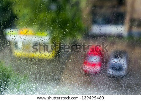 Rainy day in Moscow area. View of a yard of the inhabited massif in Moscow area through wet glass during a rain