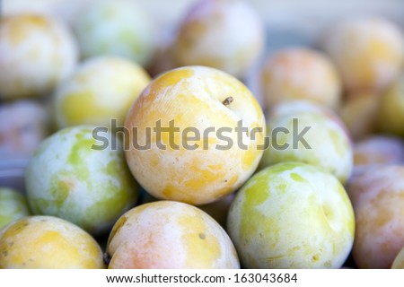 Eco-friendly products on the market stall. ripe yellow plums
