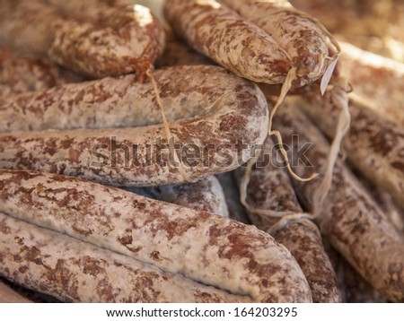 Eco-friendly products on the market stall . Smoked sausage , made according to traditional French recipes