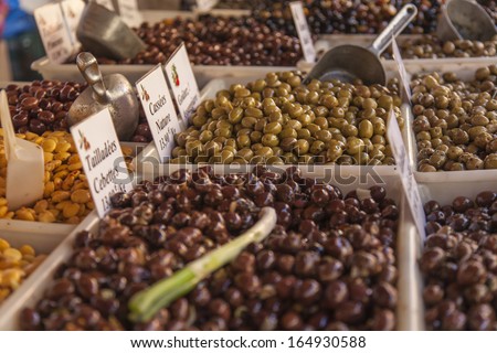 Eco-friendly products on a market stall . Different varieties of pickled olives