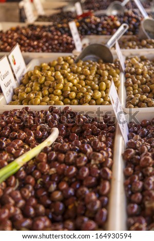 Eco-friendly products on a market stall . Different varieties of pickled olives