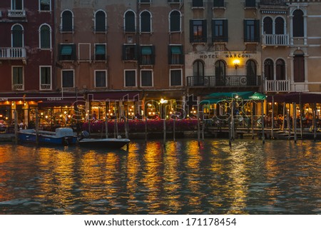 Venice, Italy, June 21, 2012 . Tourists spend the evening in a cafe on the canal bank