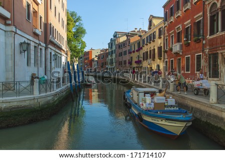 Venice, Italy . June 22, 2012 . Cargo boats carry about products on the canals of Venice