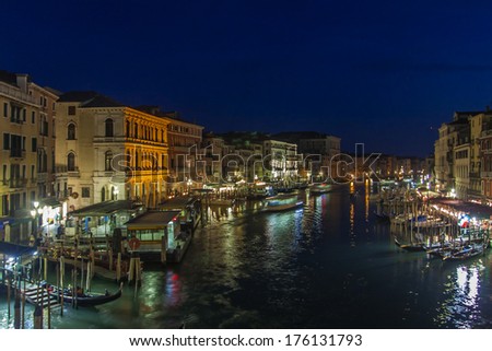 Venice, Italy, June 24, 2012 . Kind of a Venetian canal in the evening. Tourists rest in a cafe on the banks of the Grand Canal