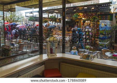 AMSTERDAM, HOLLAND -APRIL 14, 2012: View from the restaurant window to flower market in the rain