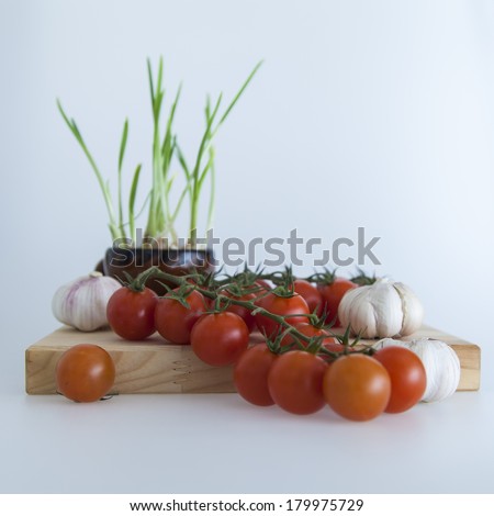 Cherry tomato varieties , garlic and garlic sprouts in salads