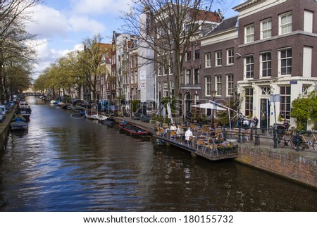 Amsterdam, The Netherlands, April 16, 2012 . Typical cityscape . Residential boats on the canal Amsterdam, The Netherlands, April 16, 2012 . Typical cityscape . Residential boats on the canal