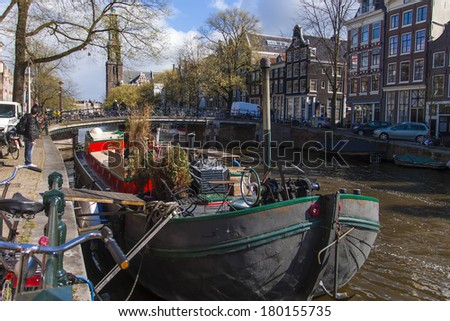 Amsterdam, The Netherlands, April 16, 2012 . Typical cityscape . Residential boats on the canal Amsterdam, The Netherlands, April 16, 2012 . Typical cityscape . Residential boats on the canal
