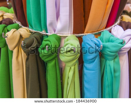 Scarves in various shades of the storefront