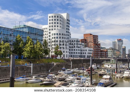 Dusseldorf, Germany, on July 6, 2014. Architectural complex of Rhine Embankment in the area Media harbor and boats at the mooring