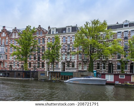 Amsterdam, Netherlands, on July 8, 2014. Typical urban view with houses on the bank of the channel