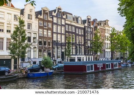 Amsterdam, Netherlands, on July 10, 2014. Typical urban view. Inhabited boats on the channel