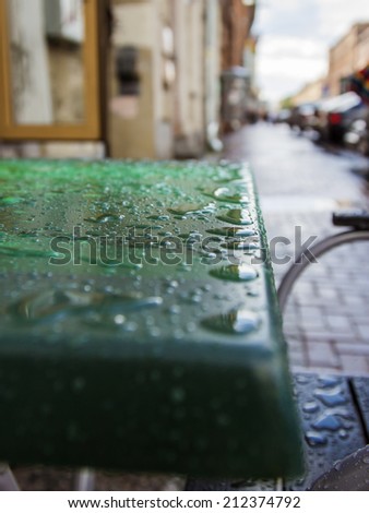St. Petersburg, Russia.  Table of summer cafe on the street with water drops after a rain