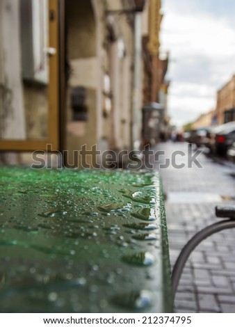 St. Petersburg, Russia.  Table of summer cafe on the street with water drops after a rain