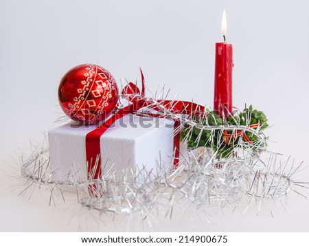 New Year\'s gift in a white cardboard box, jewelry for a fir-tree and a burning candle