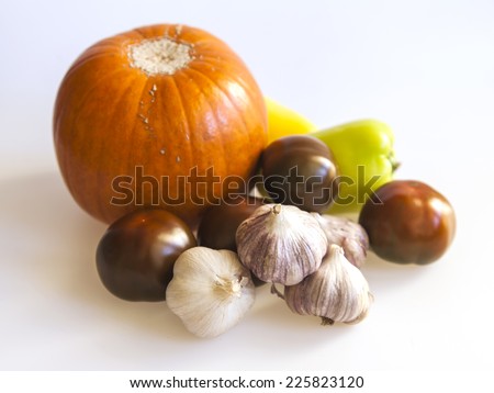 Orange pumpkin, black tomato, garlic for salad