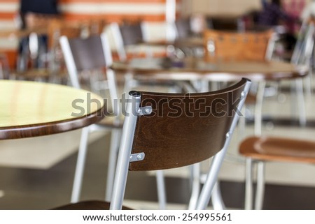 Tables and chairs in cafe in the food court of shopping center