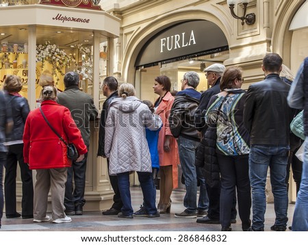 Moscow, Russia, on APRIL 12, 2015. GUM historical shop. People stand in a queue for specialty ice cream