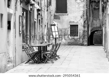 VENICE, ITALY on MAY 3, 2015. Typical city street. Old houses and small outside cafe, look in the cloudy spring morning
