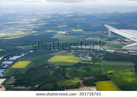 The top view from a window of the flying plane on the city and its vicinities