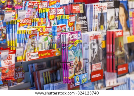 PARIS, FRANCE, on AUGUST 29, 2015. Various French magazines on a booth show-window on sale of the press