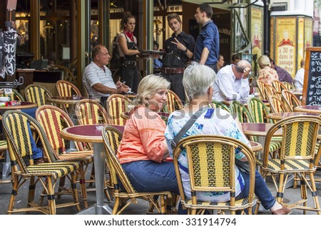 PARIS, FRANCE, on AUGUST 31, 2015. Summer cafe on the street. People eat and have a rest