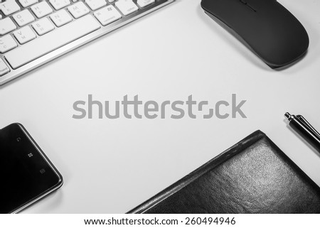 Notepad, keyboard, mouse and cell phone on white background