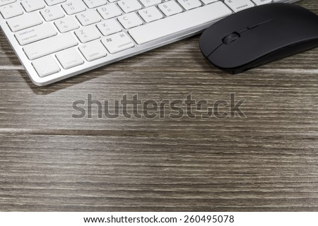 keyboard and black mouse on wood table