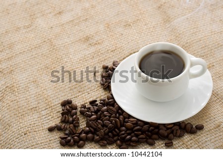 cup hot coffee with roasted coffee beans