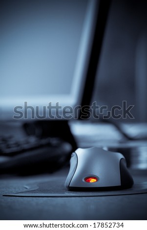 computer mouse with red led, blue toned, copy space for text