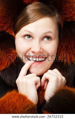 smiling sly woman in fur hood