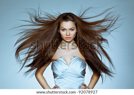 studio portrait of woman with flying hair