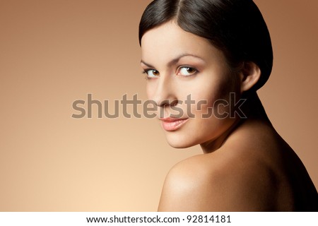 brunette woman face and shoulder over skintone background
