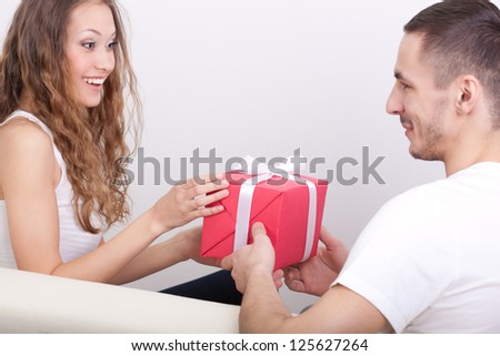 young man giving box  for his girlfriend, girl surprised