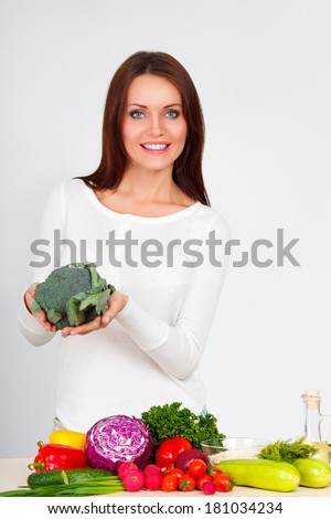 happy smiling young woman with vegetables over white wall