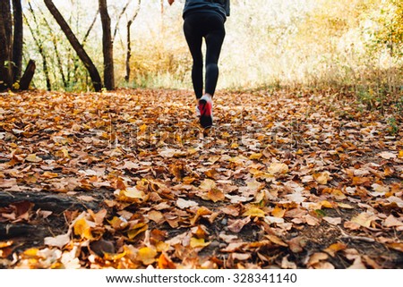 athlete woman runs for fall foliage, shoes closeup
