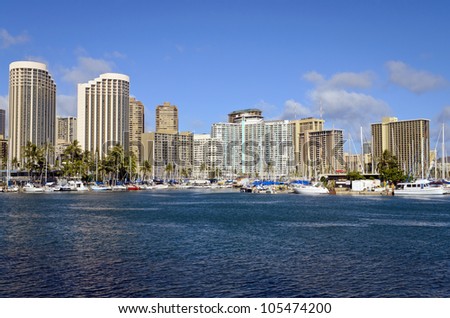 View of Honolulu Yacht Harbor from Magic Island with Honolulu buildings behind