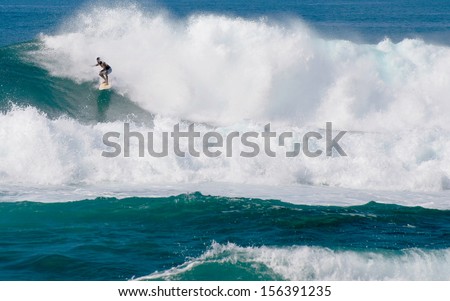 Oahu, Hawaii - January 2, 2012: A Surfer On The North Shore Of Oahu, Hawaii. In The Winter, Surfers Travel From Afar To Take Advantage Of Swells Originating In The Stormy North Pacific.