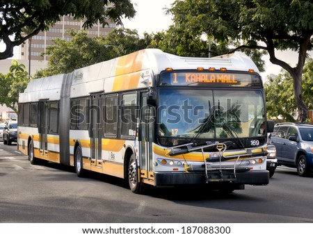 HONOLULU - APRIL 2, 2014: A Hybrid bus rides through Honolulu on April 2, 2014  The city of Honolulu purchased 60 clean diesel buses during 2013 to be more environmentally friendly.