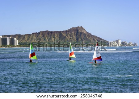 WAIKIKI, HAWAII - FEBRUARY 18, 2015: View of boats floating past Diamond Head in Honolulu, Hawaii.  Diamond Head is a defining feature of the view known to residents and tourists of Waikiki.