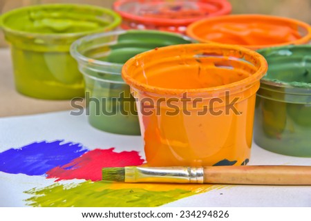 Brush paint with cup of color