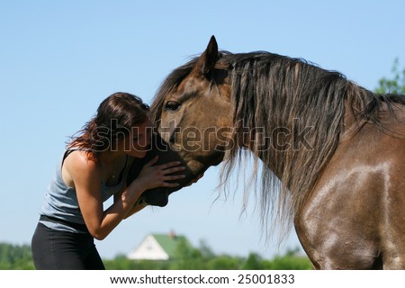 young girl and the horse in field