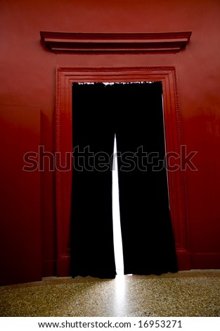 A black curtain in a red entrance