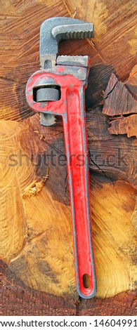 Adjustable spanner on wood background